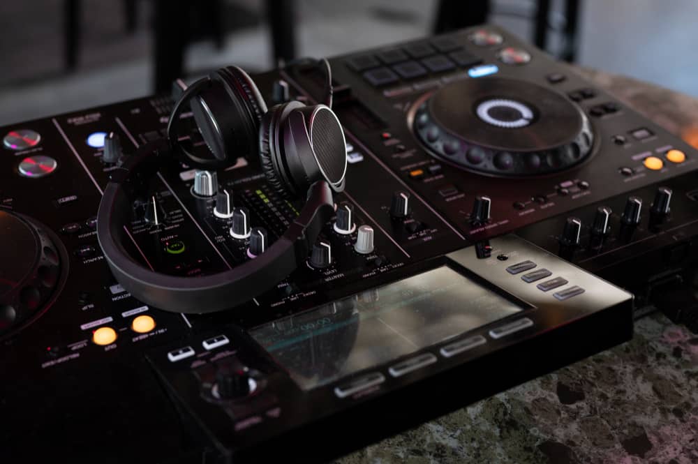 Što DJ-u za Vjenčanje Treba od Prostora i Opreme? Kompletan Tehnički Vodič za Mladence (Struja, Pozornica, Rasvjeta) 1 oprema, logistika, vodić, za dj-a za vjenčanja, slika dj pulta i slušalice stoje na mixeti